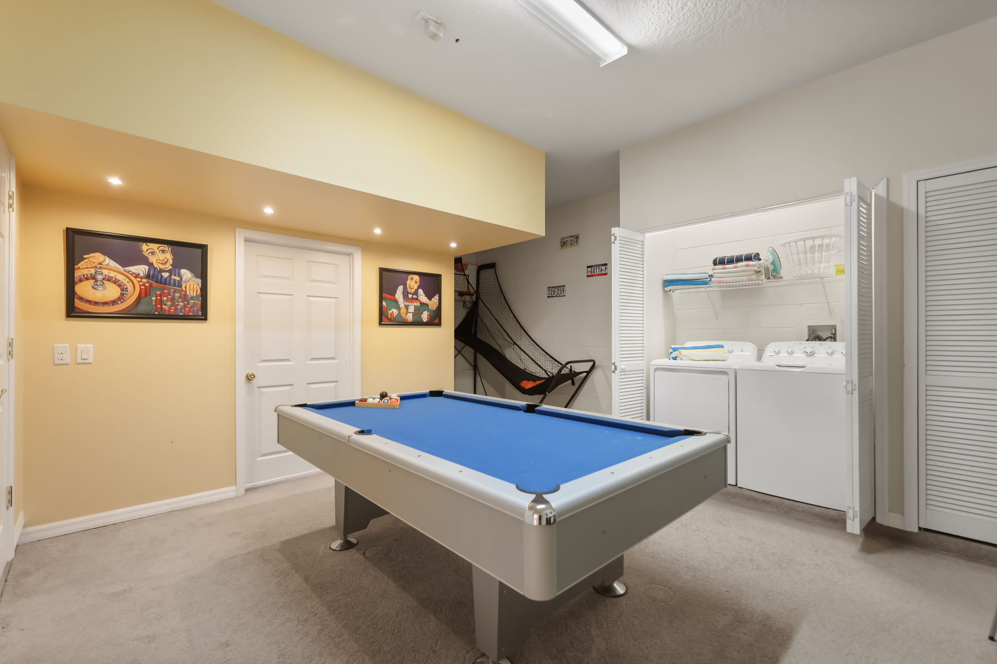 Converted garage games room with pool table and basketball game